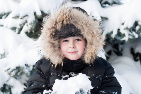 Boy in a snowy forestの写真素材