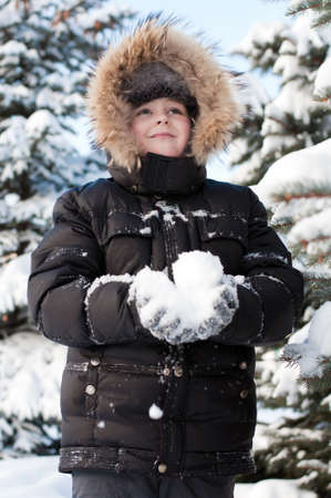 Boy in a snowy forestの写真素材