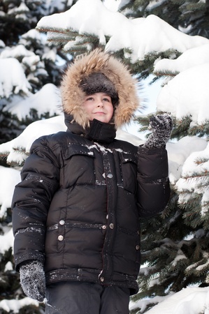 Boy in a snowy forestの写真素材
