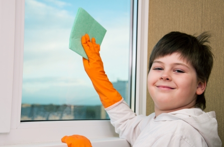 A boy washes a windowの写真素材