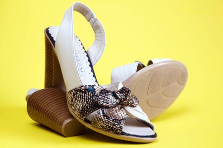Women's summer shoes on a yellow backgroundの写真素材