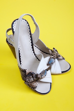 Women's summer shoes on a yellow backgroundの写真素材