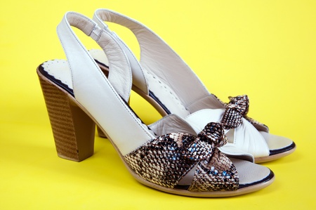 Women's summer shoes on a yellow backgroundの写真素材