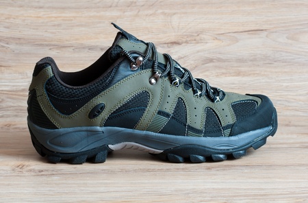 Men's running shoes on a wooden backgroundの写真素材