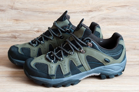 Men's running shoes on a wooden backgroundの写真素材