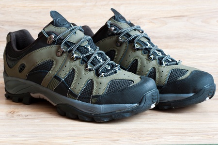 Men's running shoes on a wooden backgroundの写真素材