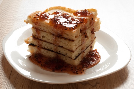 A stack of pancakes with jam gooseberryの写真素材