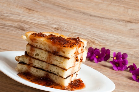 A stack of pancakes with jam gooseberryの写真素材