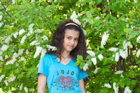 Girl with cherry blossoms treeの写真素材