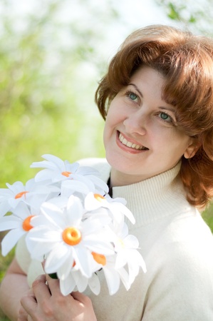 Woman with a bouquet of daisiesの写真素材