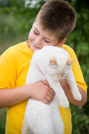 Boy with a white catの写真素材