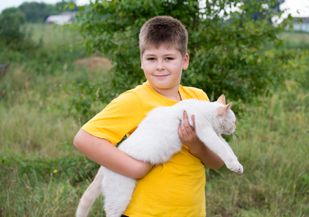 Boy with a white catの写真素材