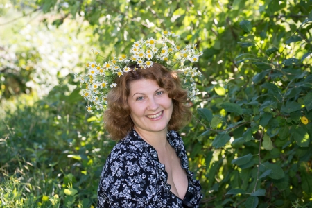 A woman with a wreath of daisies on her headの写真素材