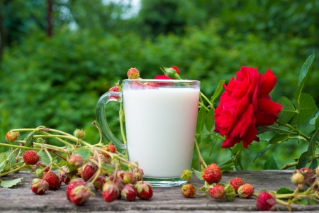 Cup of milk and fresh strawberriesの写真素材