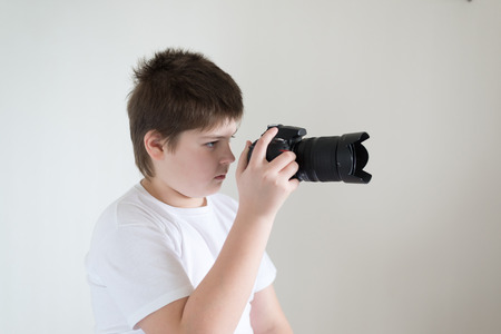 A teenage boy with camera on lightの写真素材