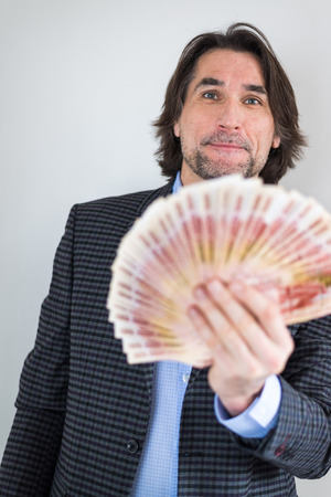 man with Russian money in his handsの写真素材