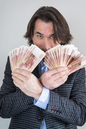 man with Russian money in his handsの写真素材