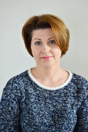 Portrait of the adult female on a light background