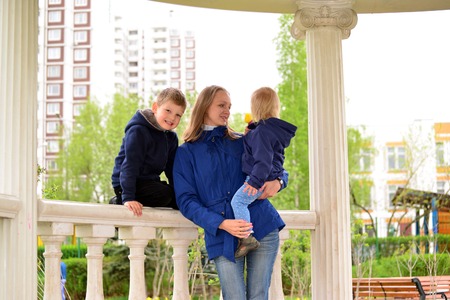 Mother with two children on a walkの写真素材