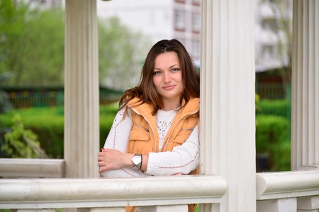 pretty young woman in a gazebo in the parkの写真素材