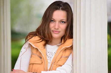 pretty young woman in a gazebo in the parkの写真素材