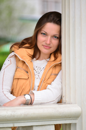 pretty young woman in a gazebo in the parkの写真素材