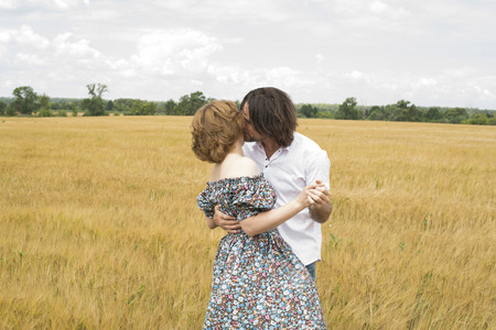 Loving middle-aged couple standing in a field in summerの写真素材