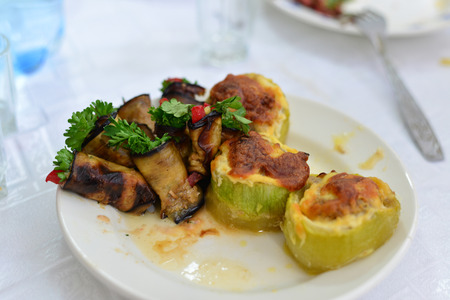 eggplant and zucchini stuffed with meat, rice, and mushrooms with grated cheeseの写真素材