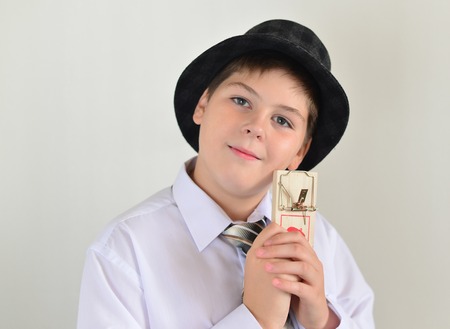 Boy teenager with a mousetrap in the hands of