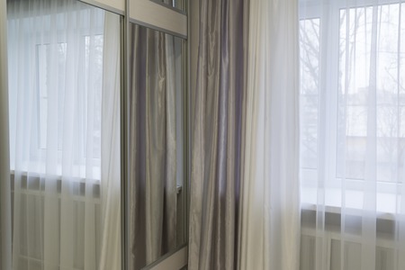 Fragments of silk curtains on the window
