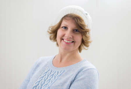 Portrait of a woman in a white knitted cap