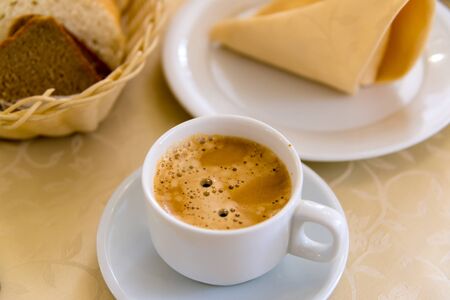 White cup of coffee on the tableの写真素材