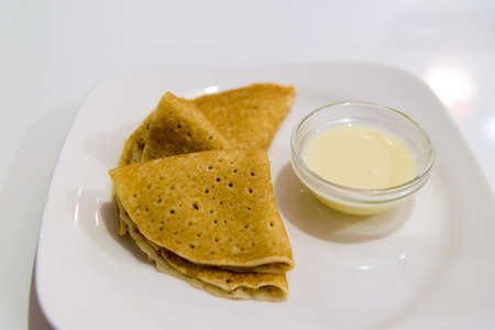 Pancakes with condensed milk on the plateの写真素材