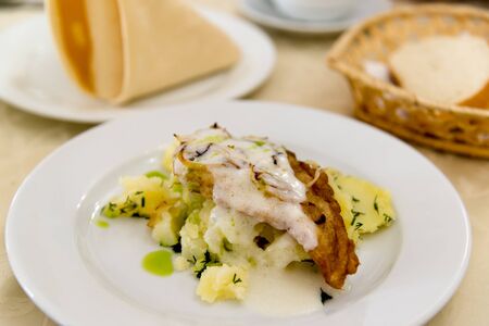 Boiled potatoes and cod in a batter