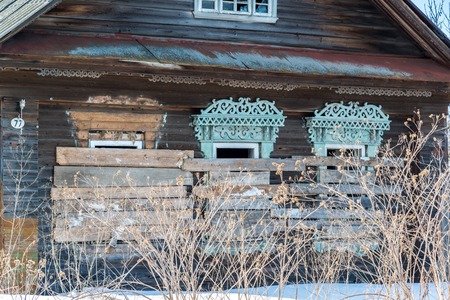 Abandoned rural wooden house with boarded up windows in Russiaの写真素材
