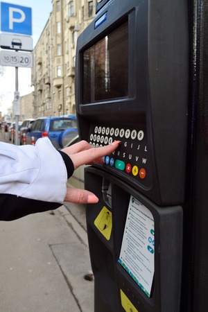 Moscow, Russia - March 14, 2016. Woman's hand enters the data in the parking payment machineのeditorial素材