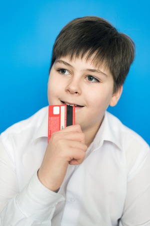 A funny teenage boy with a bank card