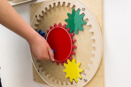 child playing of educational games hanging on the wall