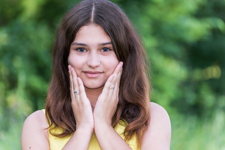 beautiful girl 14 years old posing on the nature of the summer