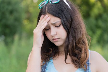 Portrait of a sad teen girl on natureの写真素材