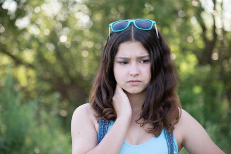 Portrait of a sad teen girl on natureの写真素材