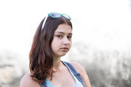 Girl with a sunglasses on her head posing in nature, toned imageの写真素材
