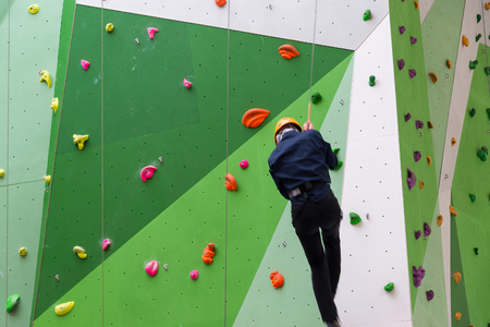 Moscow, Russia - August 30, 2016. The Teen on climbing wall in shopping complex Zelenoparkのeditorial素材