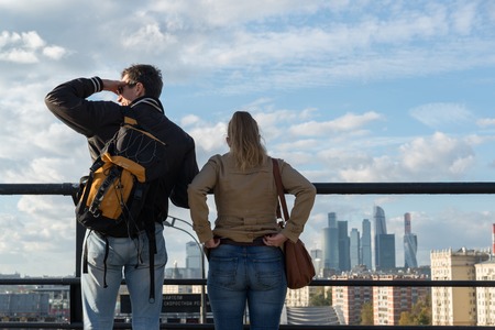 Moscow, Russia-October 01.2016. Man and woman on a viewing platform looking at Moscow Cityのeditorial素材