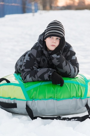 Teenager lying on green tubingの写真素材