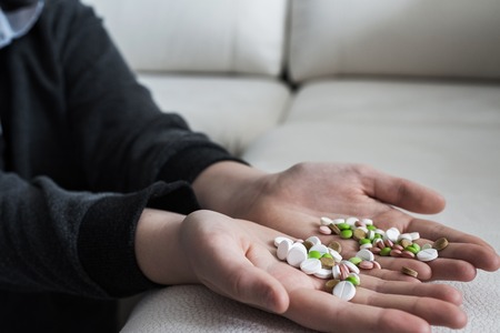 Many tablets in the hands of a teenager