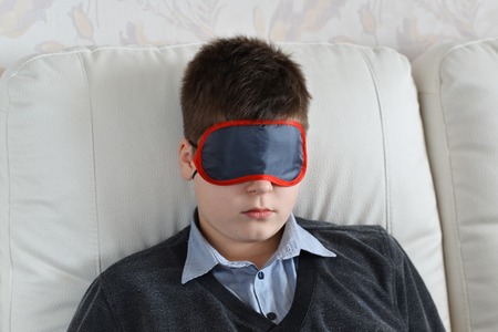 Teen rest during the day in a mask for sleepの写真素材
