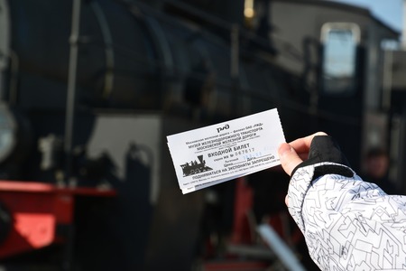 Moscow, Russia - April 1.2017. Childs hand keeps a discount ticket in Museum of History of a Railway Transport Developmentのeditorial素材