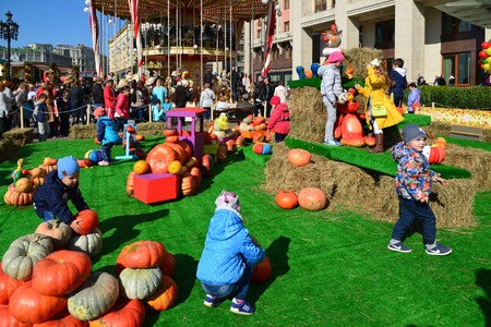 Moscow, Russia - September 23. 2017. Children play around carousel on Golden Autumn festival at Manezhnaya Squareのeditorial素材