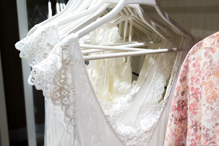 White nightgowns hang in storeの写真素材